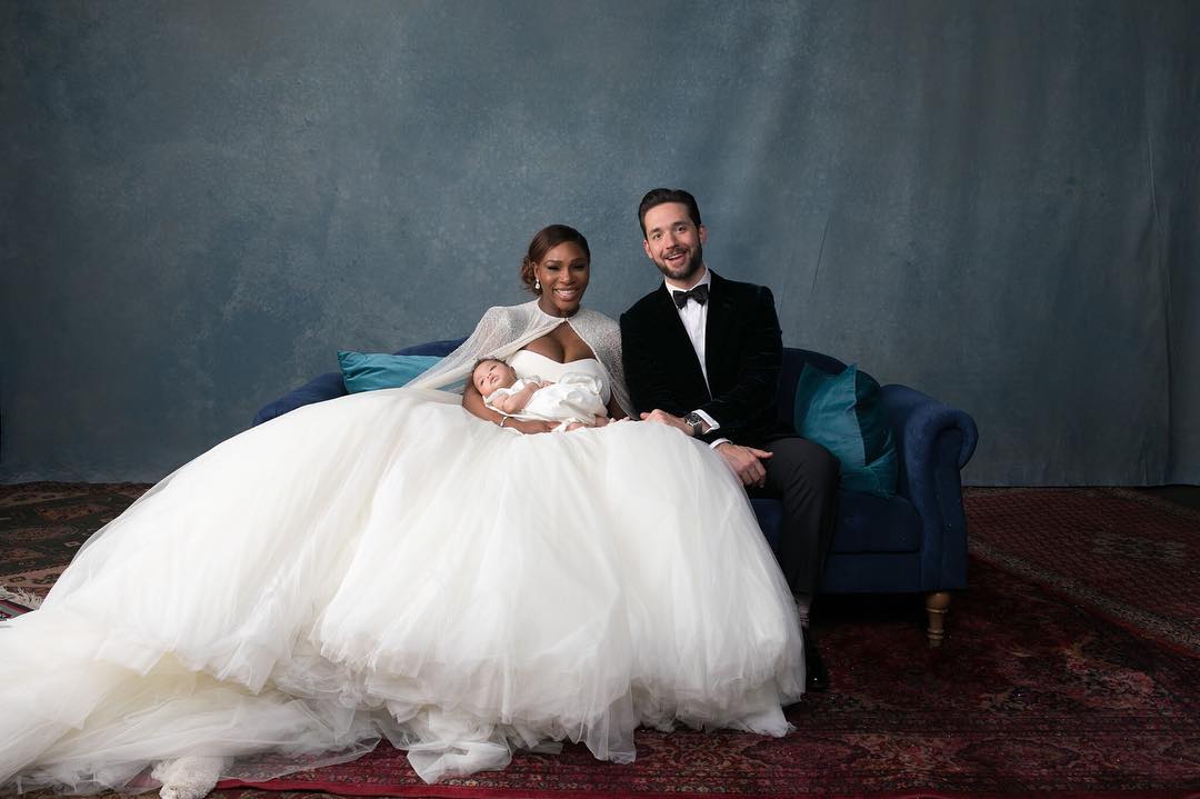 Family moment for Serena Williams, Alexis Ohanian, and their child on a couch.