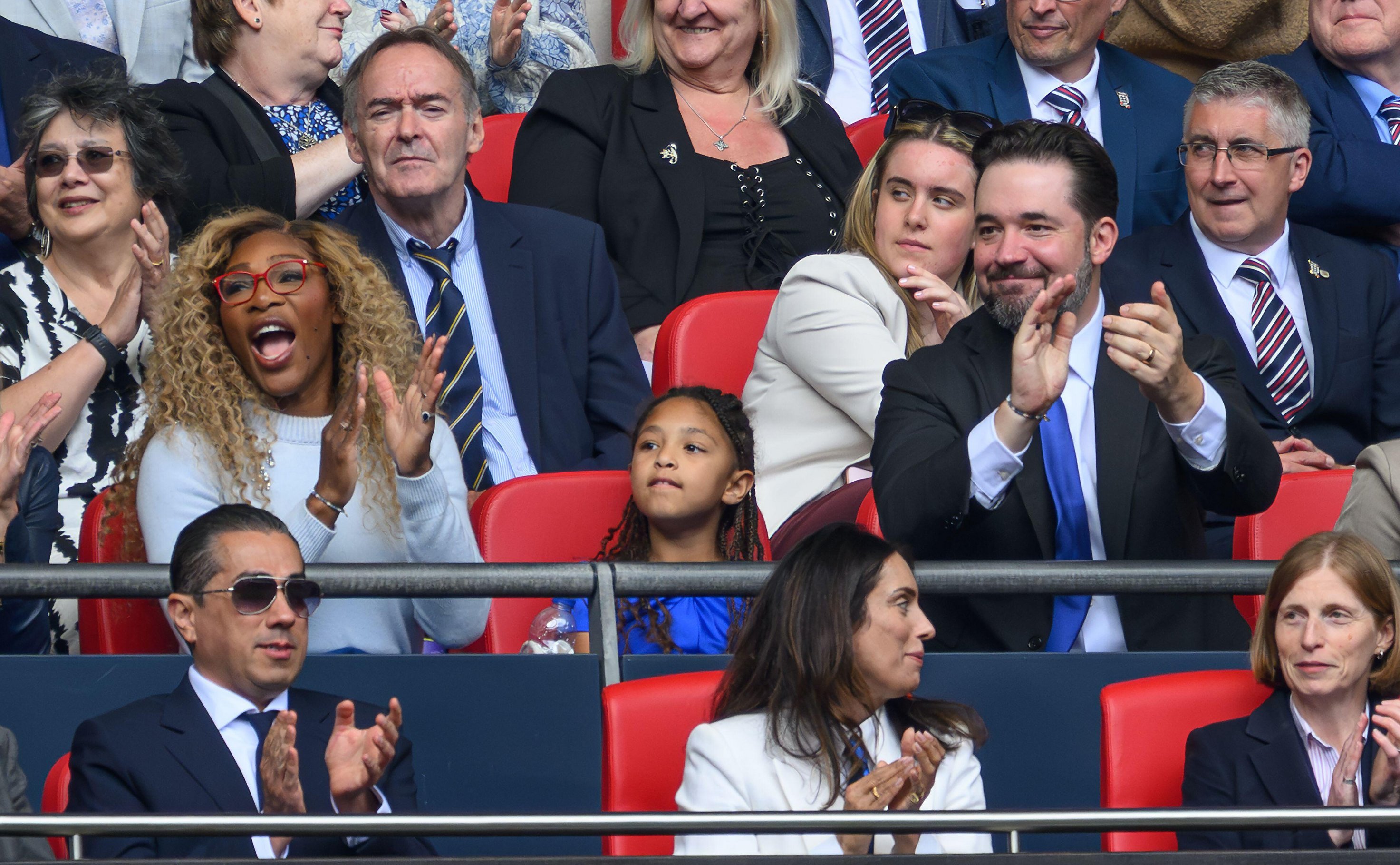 Serena Williams, Alexis Ohanian, and their daughter at a Chelsea soccer game.
