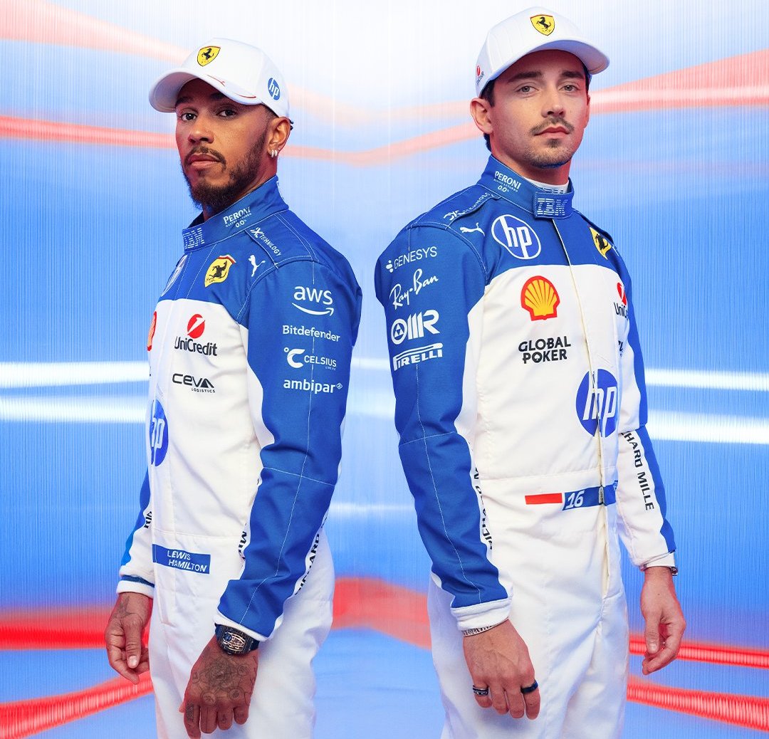 Two Formula 1 drivers in blue and white racing suits.