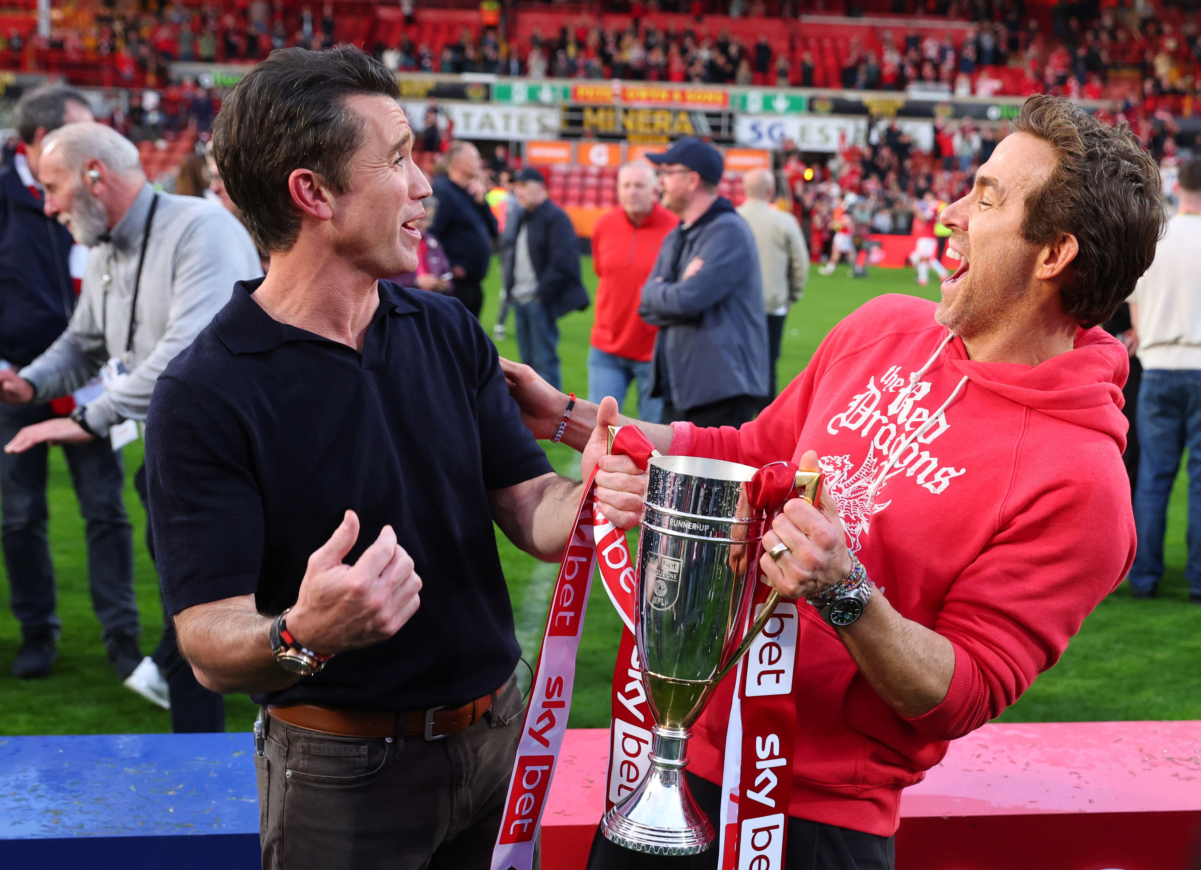 Rob McElhenney and Ryan Reynolds celebrating Wrexham's success.